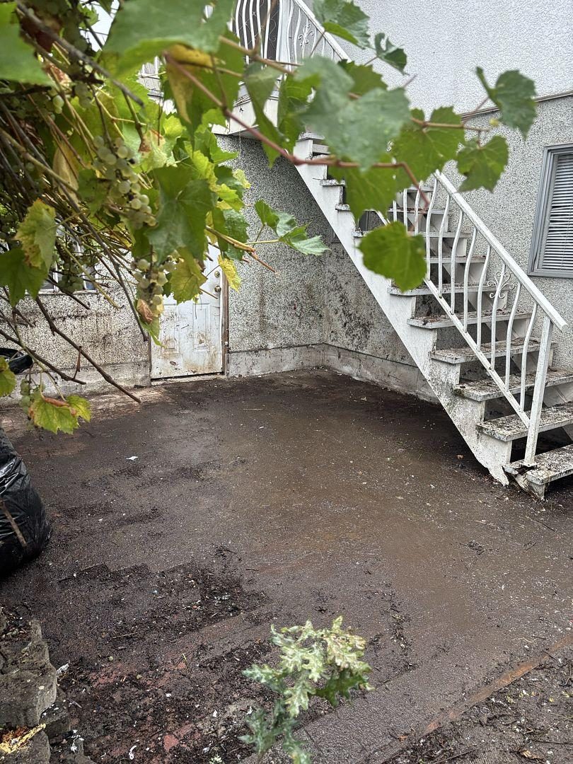 After: cleared yard beneath the back stairs